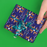 Christmas Reindeers Blue Seamless Pattern Wrapping Paper<br><div class="desc">A charming design featuring reindeers with Santa surrounded by festive holiday botanicals—holly, mistletoe, and glowing lanterns—set against a rich blue background. Playful snowflakes and twinkling stars are scattered throughout, adding a whimsical winter feel. This festive wrapping paper is perfect for adding a magical touch to holiday gift wrapping, decorating wreaths,...</div>