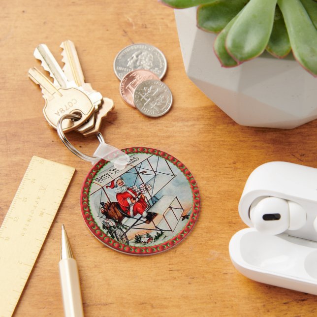 Christmas Santa flying a old aeroplane Key Ring (Desk)