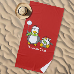 Christmas Snowballing penguins Beach Towel