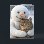 Christmas Snowman Hugging a Tabby Cat Card<br><div class="desc">A snowman with a carrot nose holds a happy tabby cat against a snowy backdrop,  where the cat has its eyes closed,  seemingly enjoying the embrace amidst falling snowflakes.
The inside text can be changed.</div>