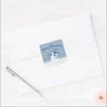 Christmas Snowman In Snowflakes Square Sticker<br><div class="desc">Cute snowman with a blue stocking cap in snowflakes on a blue background with Merry Christmas text.</div>