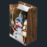 Christmas Snowman On a Park Bench Medium Gift Bag<br><div class="desc">Cute Christmas snowman on a park bench in a winter forest with sunbeams.
Text is editable.</div>