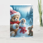 Christmas Teddy Bear Building a Snowman Holiday Card<br><div class="desc">A brown teddy bear in a hat,  earmuffs,  and red scarf builds a small snowman in a winter woods while a curious rabbit watches.</div>