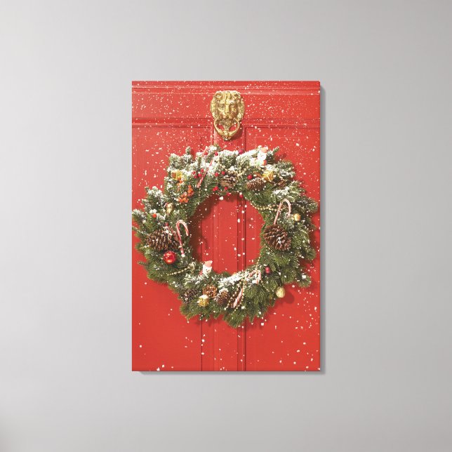 Christmas wreath hanging on a door canvas print (Front)