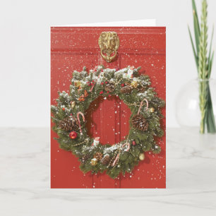 Christmas wreath hanging on a door holiday card