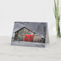 Christmas wreath on old barn with red door