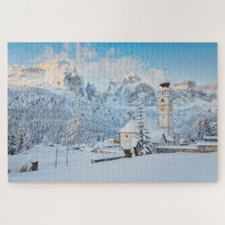 Church covered in snow with mountain background jigsaw puzzle