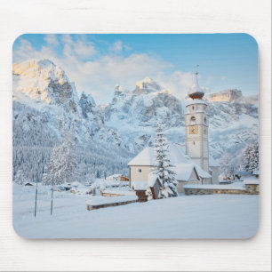 Church covered in snow with mountain background mouse mat