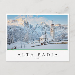 Church covered in snow with mountain background postcard