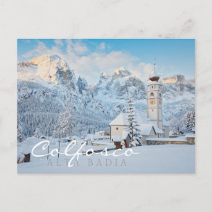 Church covered in snow with mountain background postcard