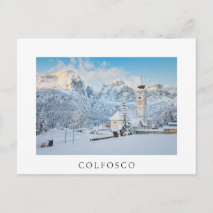 Church covered in snow with mountain background postcard