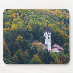 Church in a fall forest in Slovenia Mouse Mat
