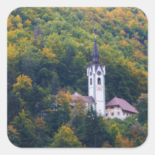 Church in a fall forest in Slovenia Square Sticker