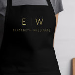 Classic Black Gold Minimalist Monogram Name Apron<br><div class="desc">Elevate your culinary experience with our Classic Elegant Modern Minimalist Monogram Name Cooking Apron. This kitchen essential seamlessly merges timeless elegance with contemporary minimalism. Crafted with precision, this apron is not just a practical accessory but also a statement of personal style. The customisable monogram and name option allows you to...</div>