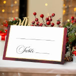 Classic Christmas Floral Crest Monogram Wedding Place Card<br><div class="desc">Timeless and elegant yet festive holiday-themed wedding place card design featuring classic hand-drawn gold floral crest accented by a colourful spray of red and white Christmas flowers and evergreens. This custom formal template includes editable text fields for guest name and table number as well as custom calligraphy text graphics and...</div>