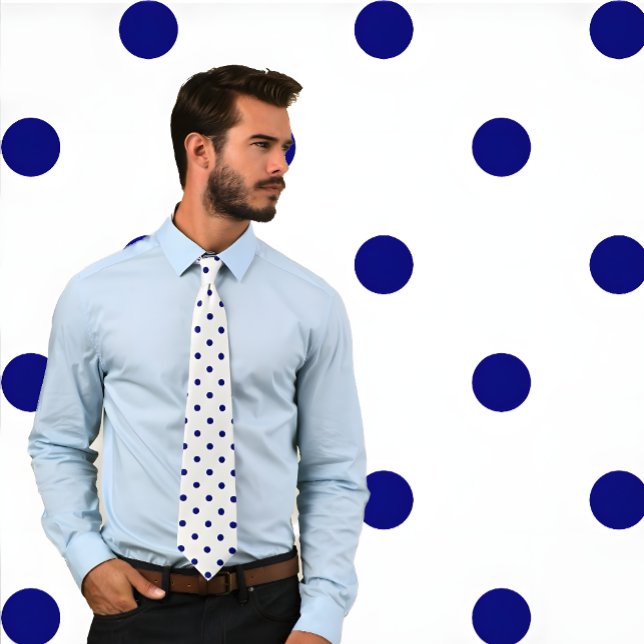 Classic Navy Polka Dot Pattern on White Tie (Handsome man wearing a Classic Navy Polka Dot Pattern on White Tie stands against polka dot pattern.)