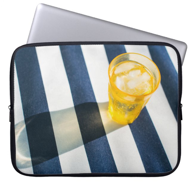 Clear drinking glass with yellow liquid laptop sleeve (Front)