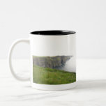 CLIFFS OF MOHER Two-Tone COFFEE MUG<br><div class="desc">One of Ireland’s most celebrated sights, the Cliffs of Moher are completely vertical and the cliff edge is immediate. On a clear day, the views are tremendous, with islands etched on the waters of Galway Bay. It’s a beautiful sight people around the world have ventured to experience in person. From...</div>