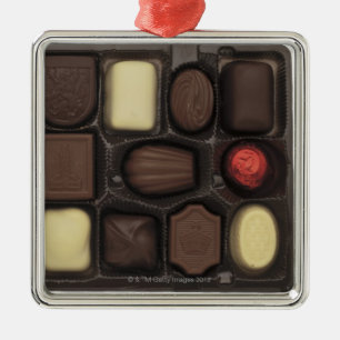 close-up of a box of assorted chocolates metal tree decoration