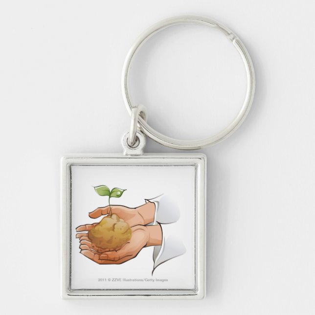 Close-up of a person's hands holding seedling key ring (Front)