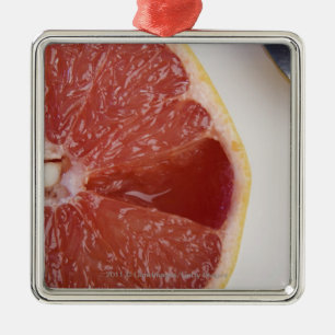 Close-up of a slice of orange and a spoon metal tree decoration