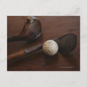 Close up of antique golf clubs and golf ball postcard