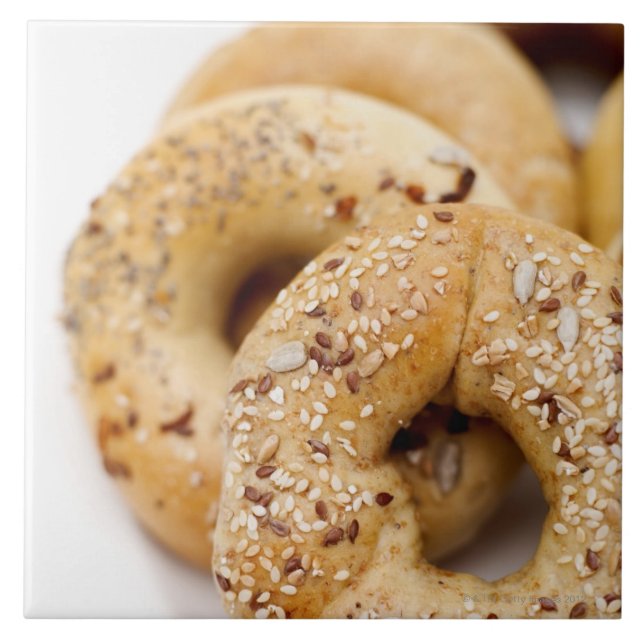 Close-up of assorted bagels on a plate tile (Front)