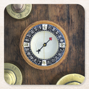 Close Up Of Chinese Compass And Gold Weights Square Paper Coaster