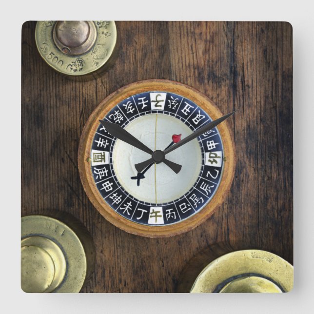 Close Up Of Chinese Compass And Gold Weights Square Wall Clock (Front)