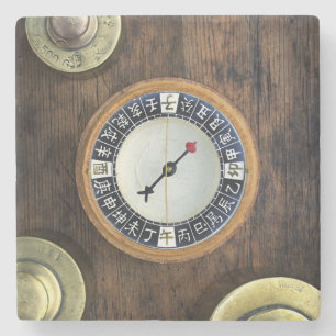 Close Up Of Chinese Compass And Gold Weights Stone Coaster