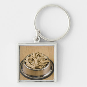 Close-up of dog biscuits in a dog bowl key ring