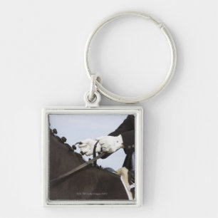 close-up of dressage horse with rider key ring