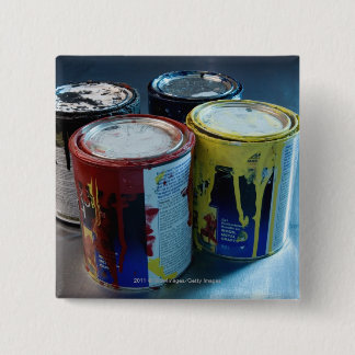 Close-up of four paint cans 15 cm square badge