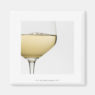 Close up of glass of white wine on white magnet