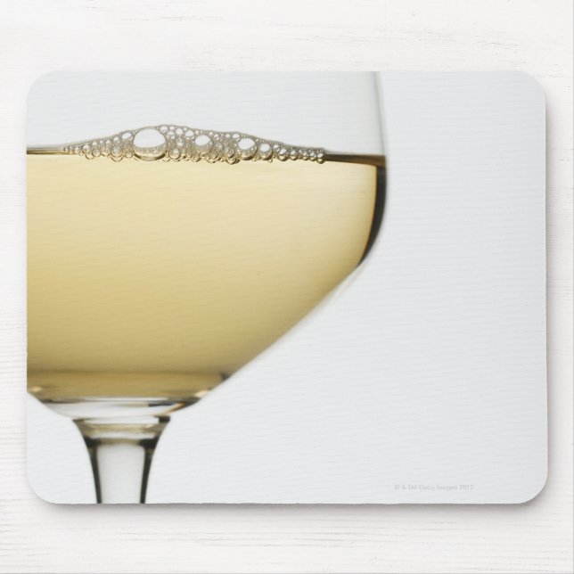 Close up of glass of white wine on white mouse mat (Front)
