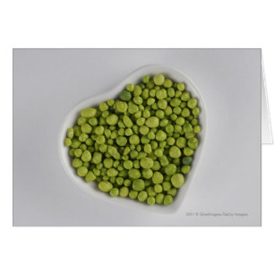 Close-up of green pebbles in a heart shape bowl