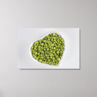 Close-up of green pebbles in a heart shape bowl