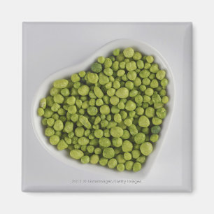 Close-up of green pebbles in a heart shape bowl magnet