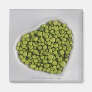 Close-up of green pebbles in a heart shape bowl magnet