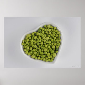 Close-up of green pebbles in a heart shape bowl poster