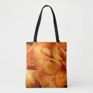 Close up of juicy, crispy, chips on black plate. tote bag