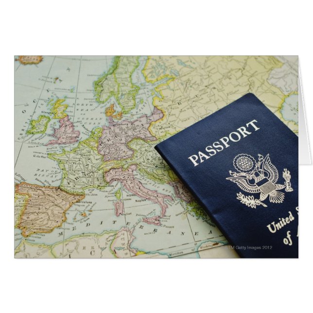 Close-up of passport lying on European map (Front Horizontal)