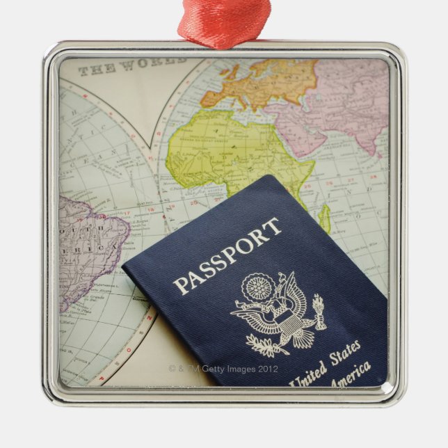 Close-up of passport lying on map metal tree decoration (Front)