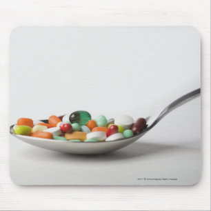Close-up of pills in a spoon mouse mat