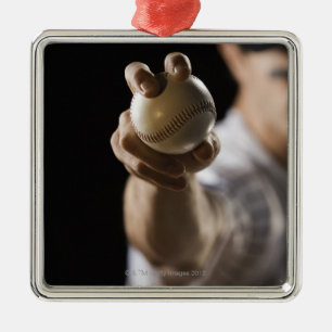 Close up of pitcher holding baseball metal tree decoration