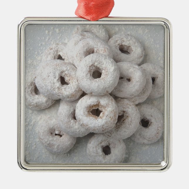 Close-up of powdered doughnuts in a plate metal tree decoration (Front)