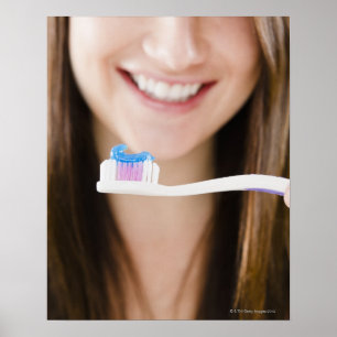 Close-up of smiling young woman holding poster