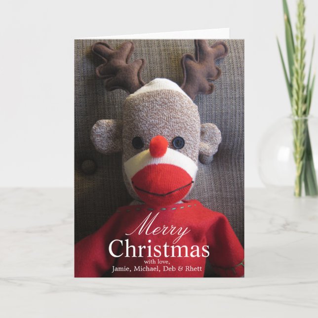 Close-up of sock monkey face with antlers, red holiday card (Front)