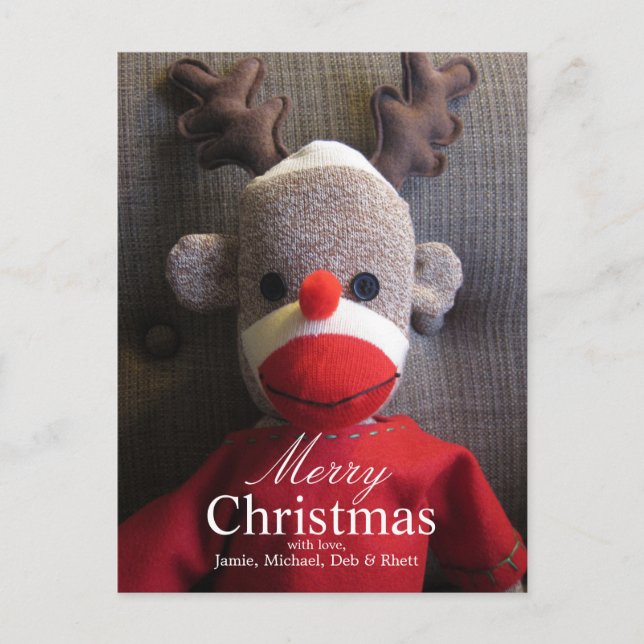 Close-up of sock monkey face with antlers, red holiday postcard (Front)