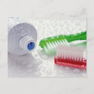Close-up of toothpaste and toothbrushes covered postcard